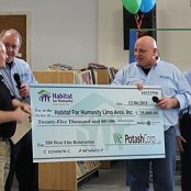 Todd Sutton of Potash Corporation of Lima presents the company's donation of $25,000 to Board President Bruce Hilty to be used toward the renovation project.